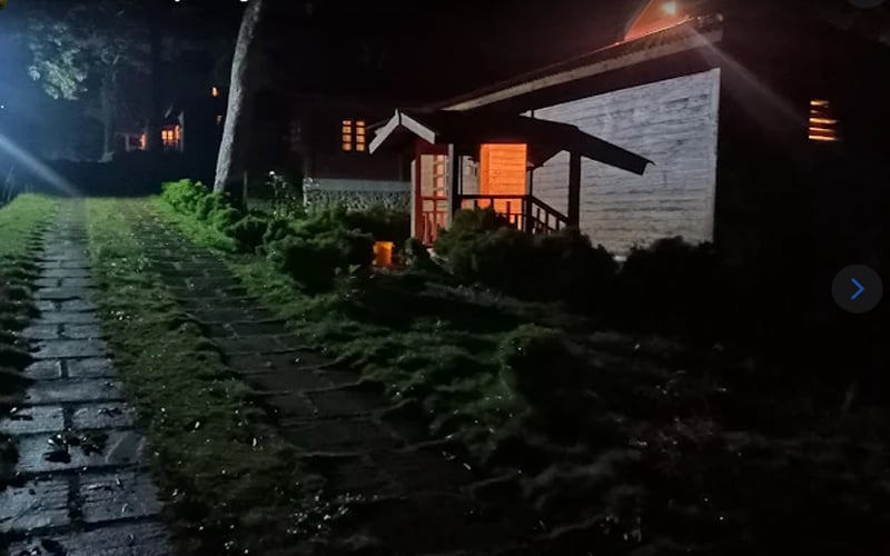 Cottage glowing warmly at night